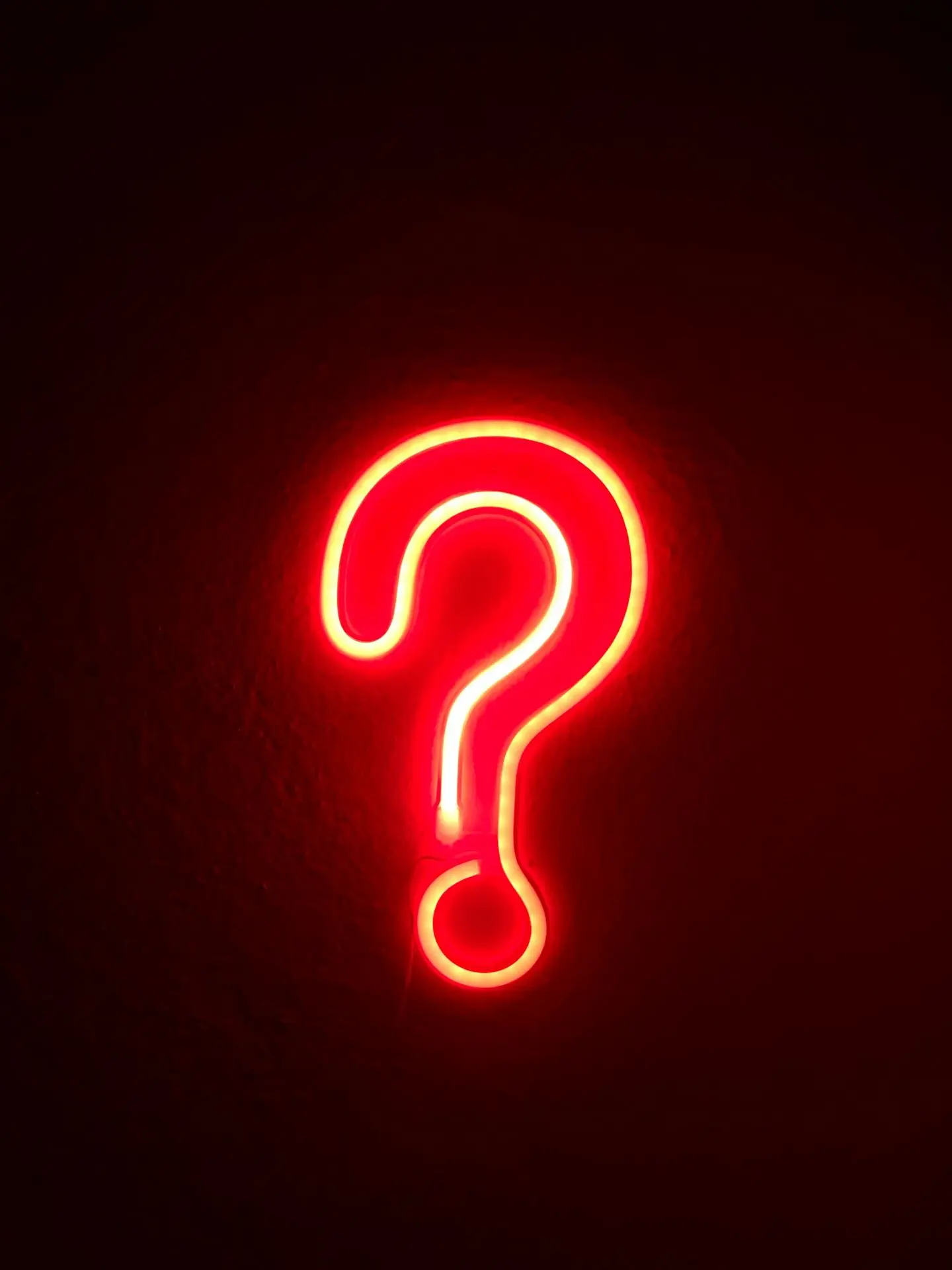 red neon question mark on wall